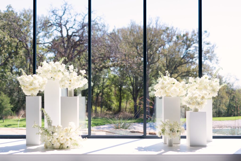 All white florals at ceremony cite